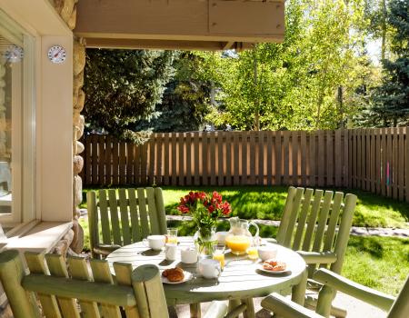 Outdoor table with 4 chairs and food on the table 