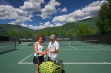 man and woman on a tennis court 